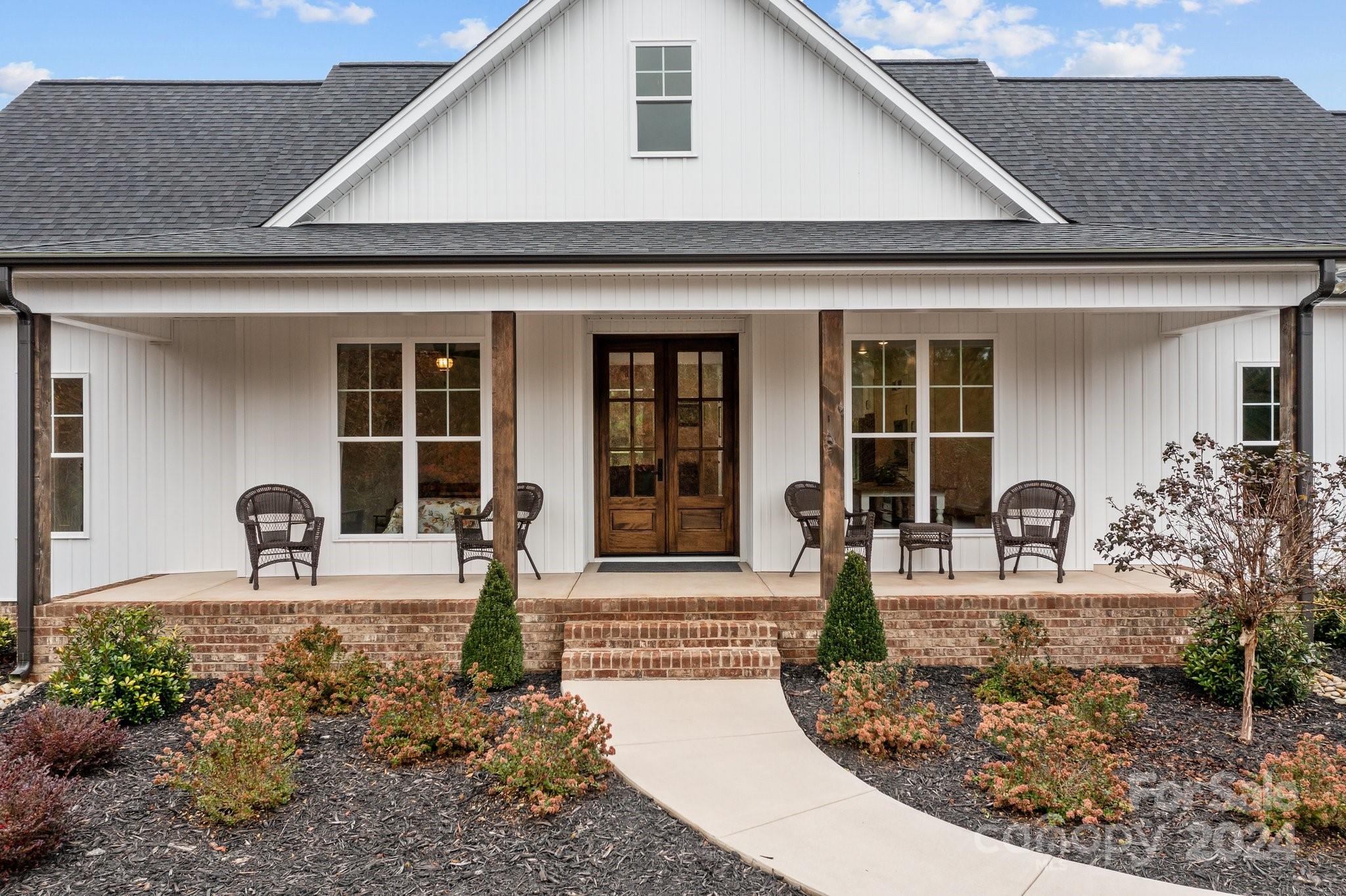 450 Bringle Ferry Road Denton, NC 27239 - Photo 5 of 48 a front view of a house with garden