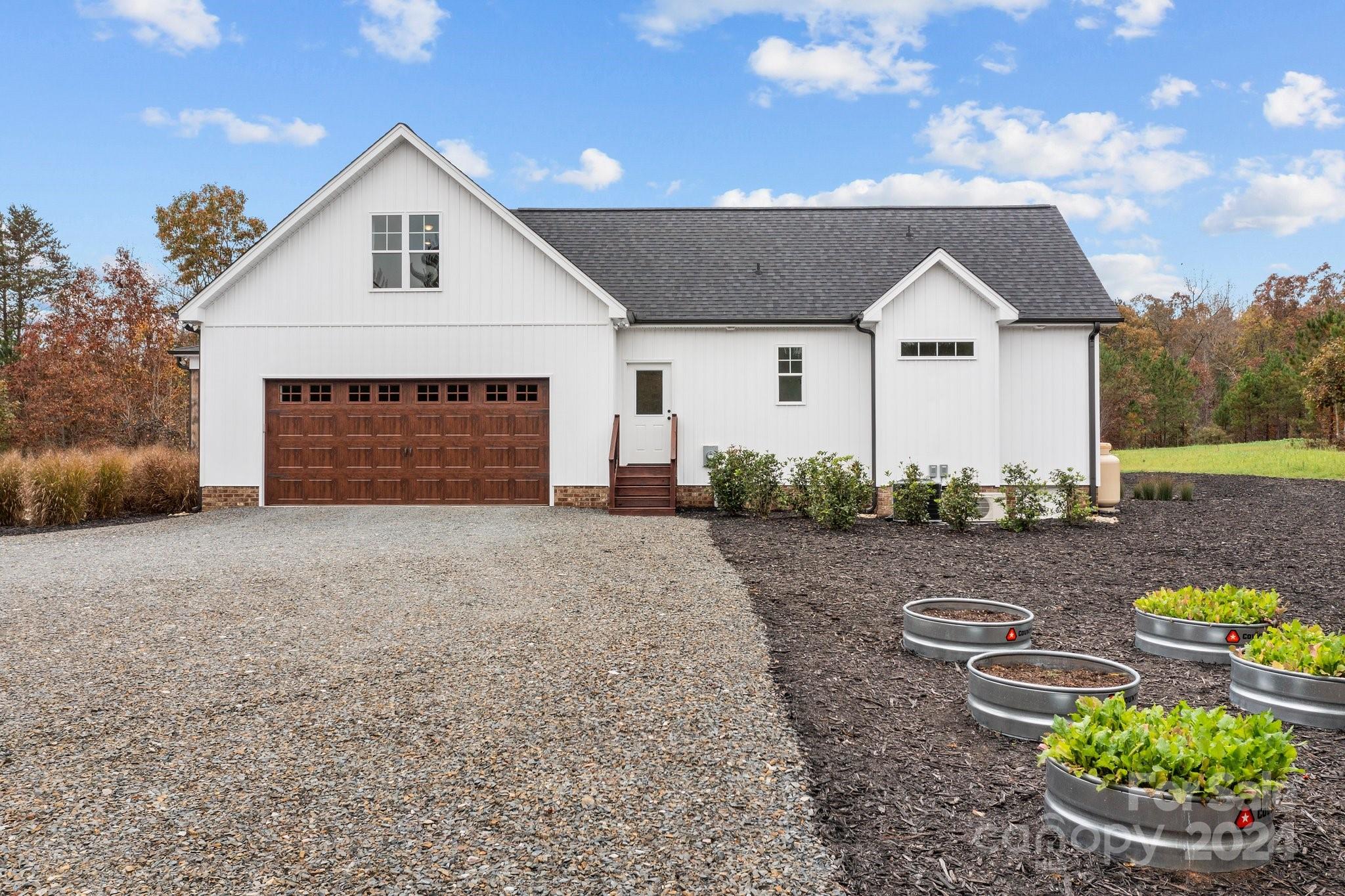 450 Bringle Ferry Road Denton, NC 27239 - Photo 8 of 48 a front view of a house with a yard and garage