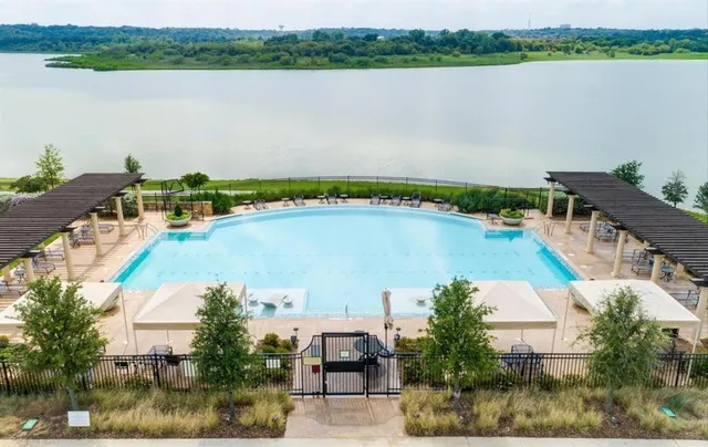 a view of a pool patio and lake view