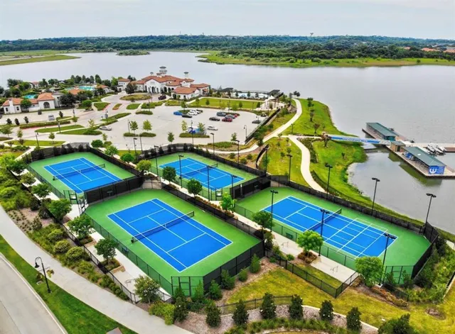 an aerial view of a house with garden space and lake view in back