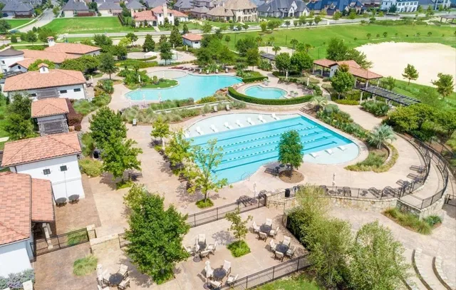 an aerial view of a house with outdoor space and lake view