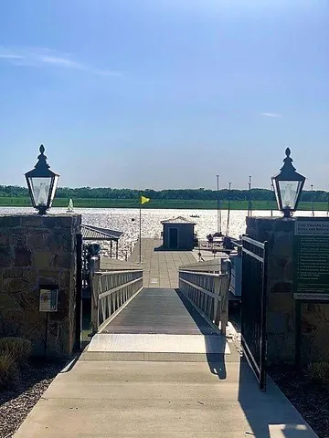 an outdoor view with two chairs and a barbeque