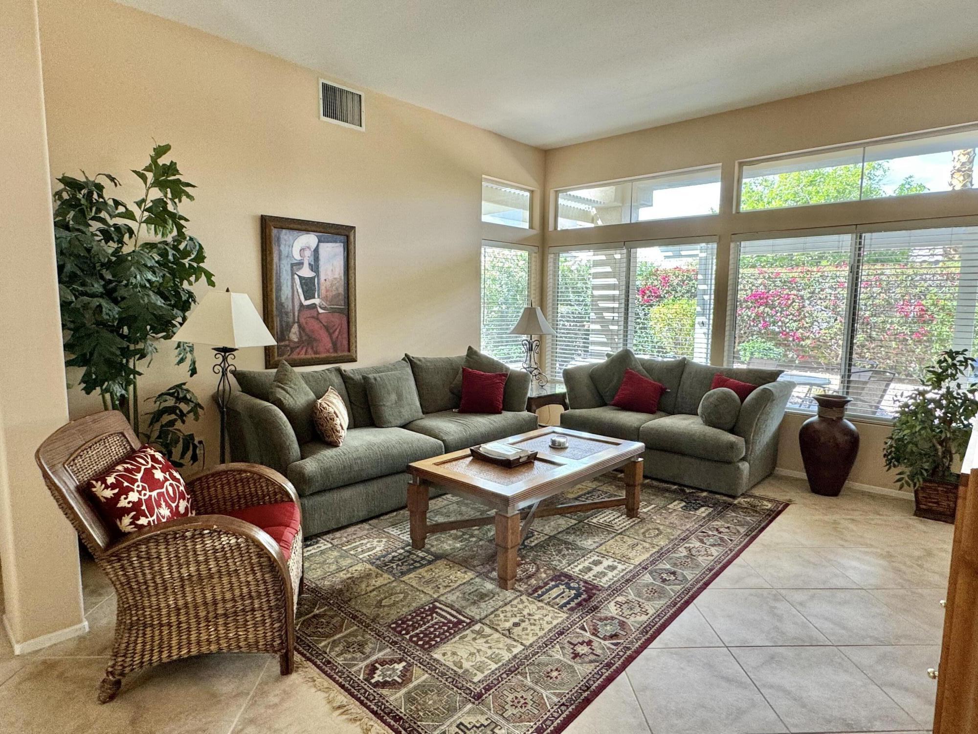 78376 Moongold Road Palm Desert, CA 92211 - Photo 2 of 36 a living room with furniture and a large window