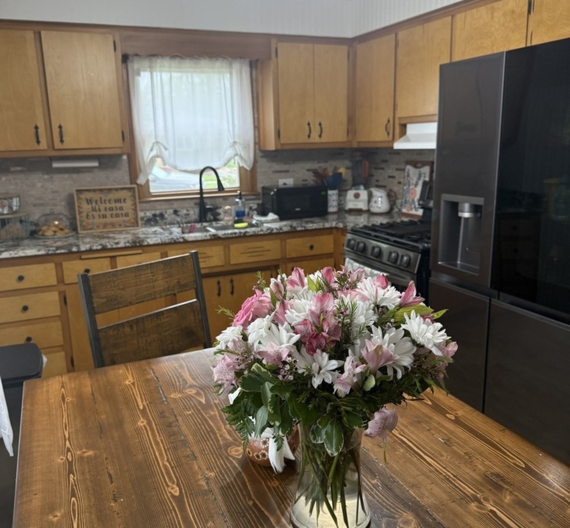 3763 153rd Street Midlothian, IL 60445 - Photo 17 of 17 a kitchen with stainless steel appliances a sink a counter top space cabinets and a potted plant
