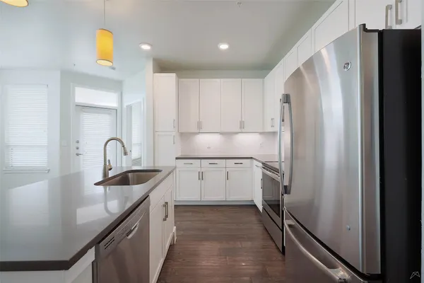 a kitchen with a refrigerator and a sink