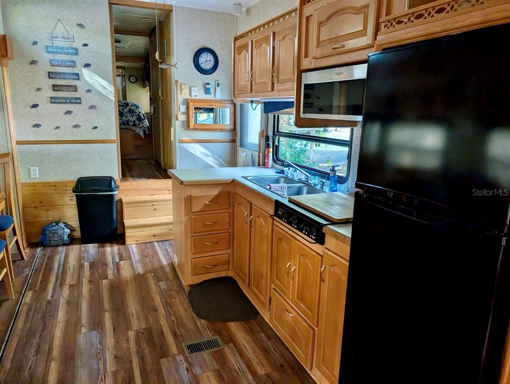 14131 Northeast 253rd Ave Road Salt Springs, FL 32134 - Photo 3 of 26 a kitchen with stainless steel appliances granite countertop a stove and a microwave