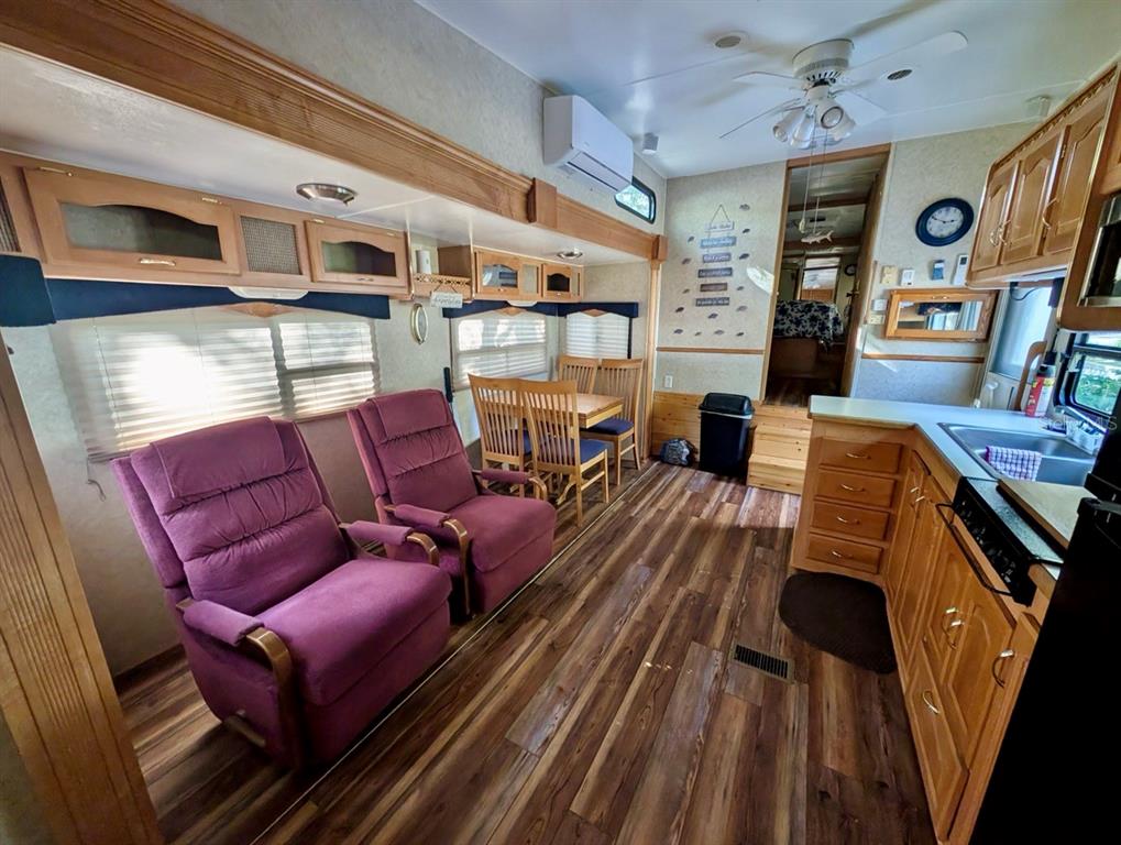 14131 Northeast 253rd Ave Road Salt Springs, FL 32134 - Photo 6 of 26 a living room with furniture fireplace and flat screen tv