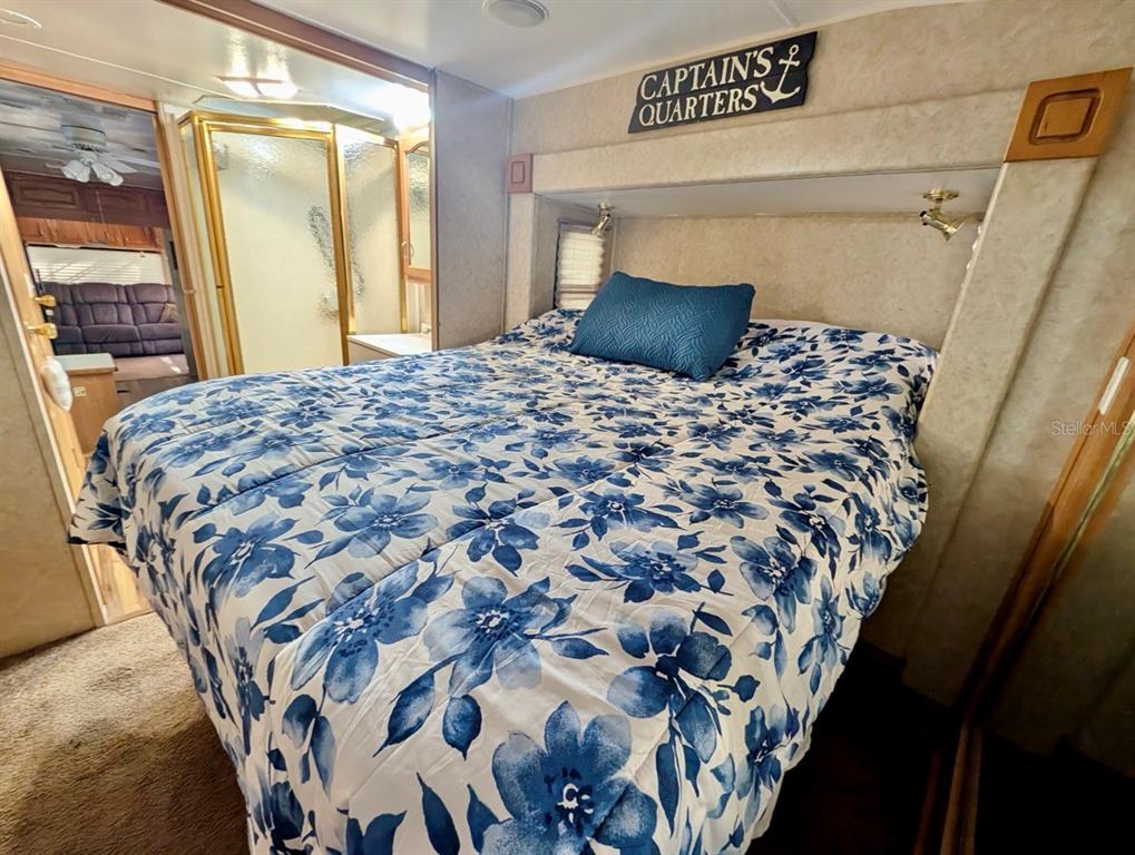 14131 Northeast 253rd Ave Road Salt Springs, FL 32134 - Photo 7 of 26 a bedroom with a large bed and a mirror