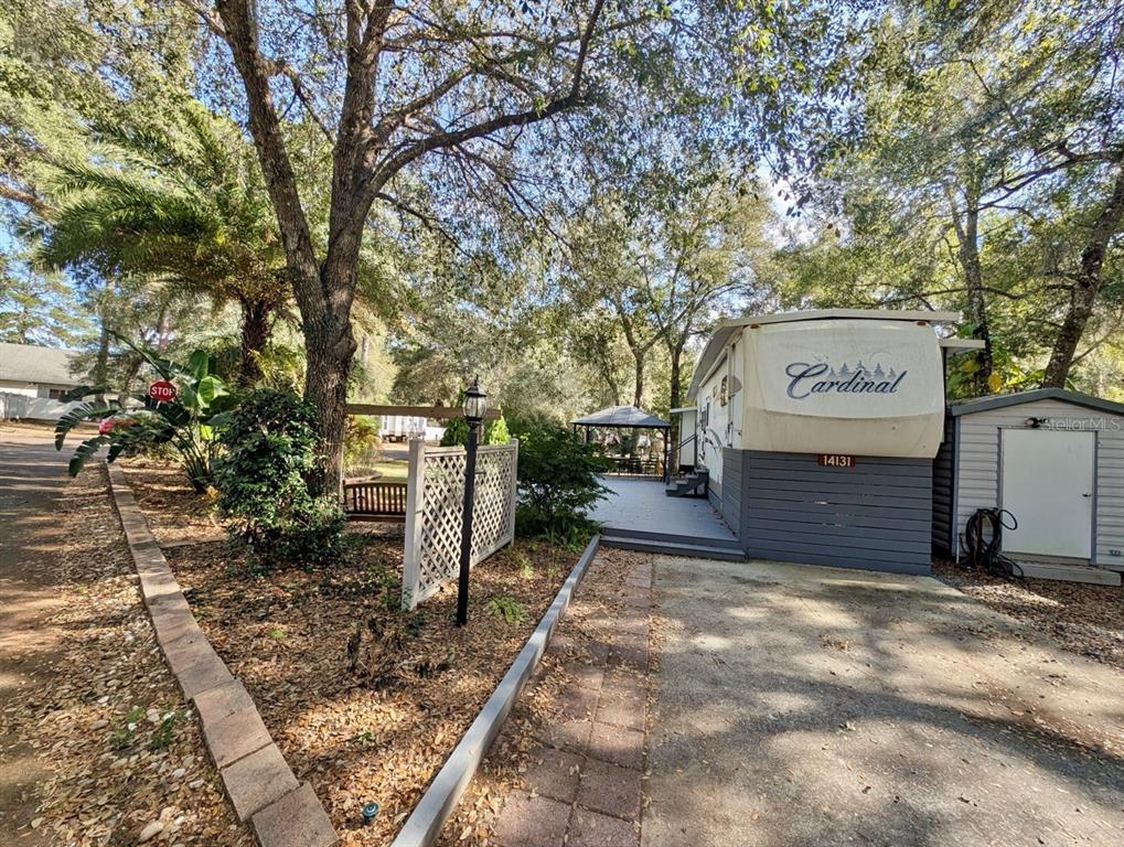 14131 Northeast 253rd Ave Road Salt Springs, FL 32134 - Photo 10 of 26 a view of a street sign under an umbrella