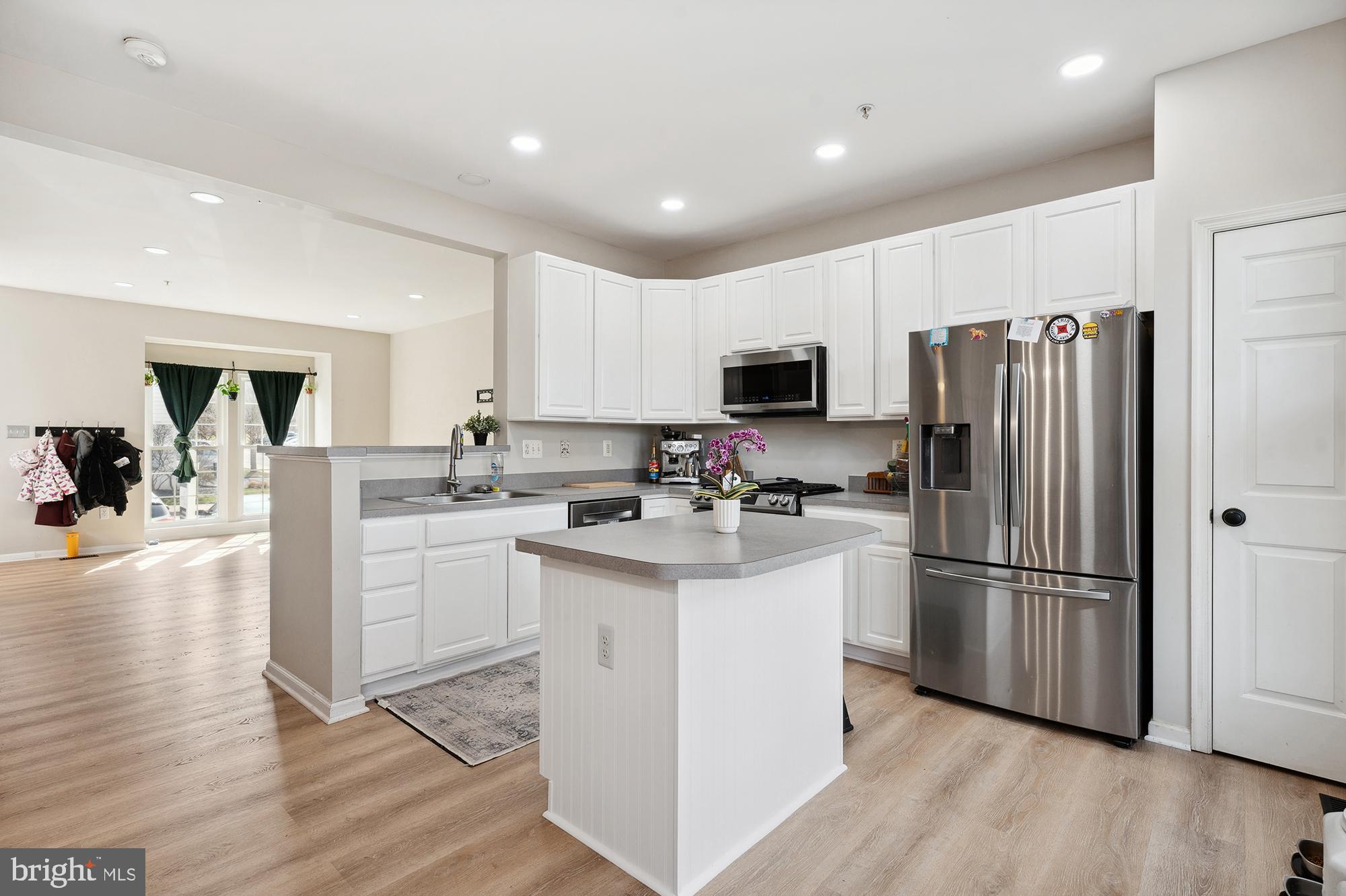 3663 Singleton Terrace Frederick, MD 21704 - Photo 11 of 34 a kitchen with kitchen island white cabinets and stainless steel appliances
