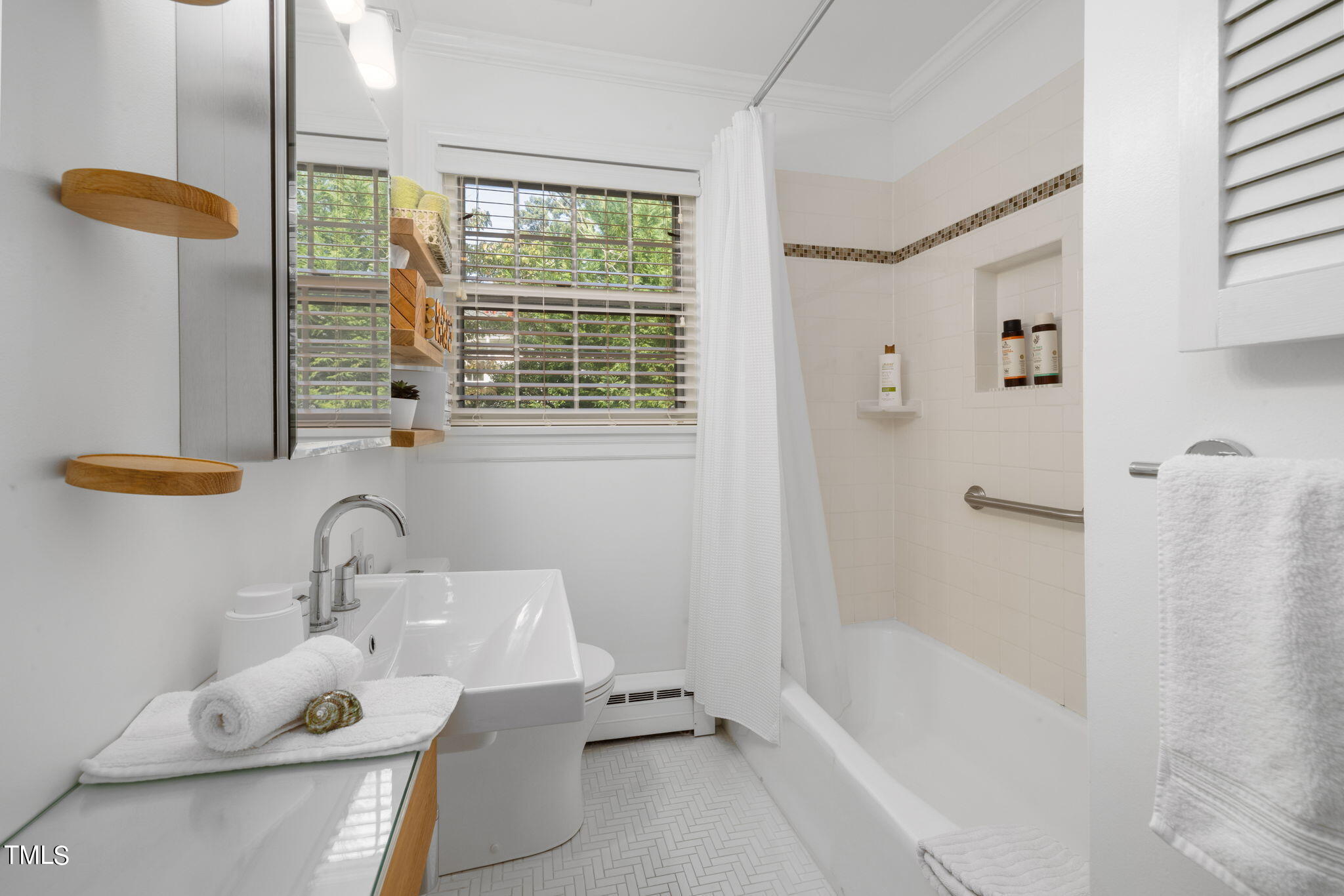 3409 Lewis Farm Road Raleigh, NC 27607 - Photo 16 of 31 a bathroom with a tub sink and mirror