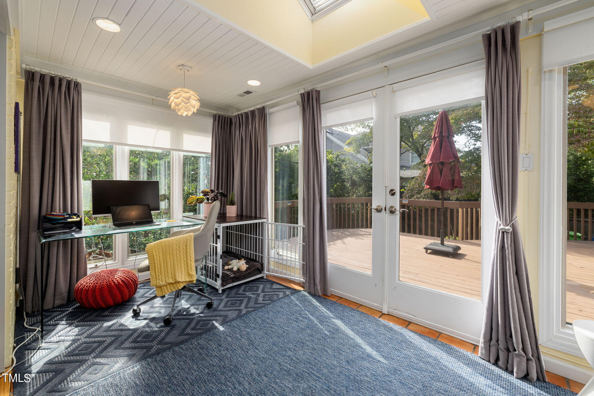 3409 Lewis Farm Road Raleigh, NC 27607 - Photo 19 of 31 a room with furniture a flat screen tv and floor to ceiling window
