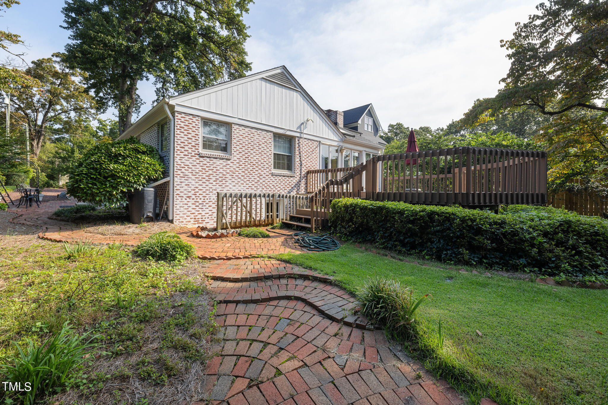 3409 Lewis Farm Road Raleigh, NC 27607 - Photo 25 of 31 a view of a white house next to a yard with big trees