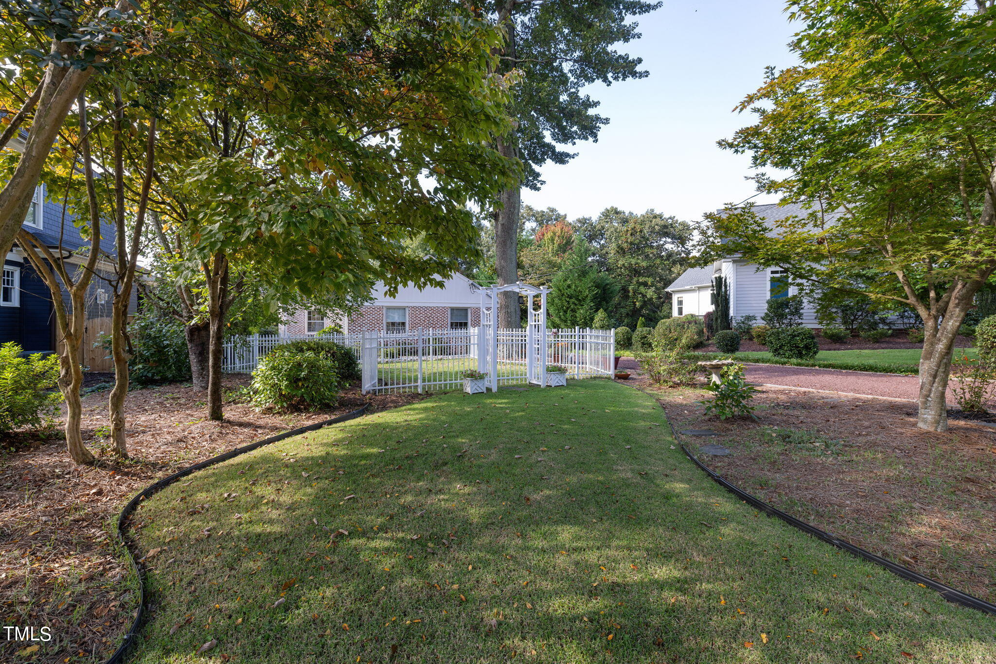 3409 Lewis Farm Road Raleigh, NC 27607 - Photo 29 of 31 a view of a garden with a house in the background