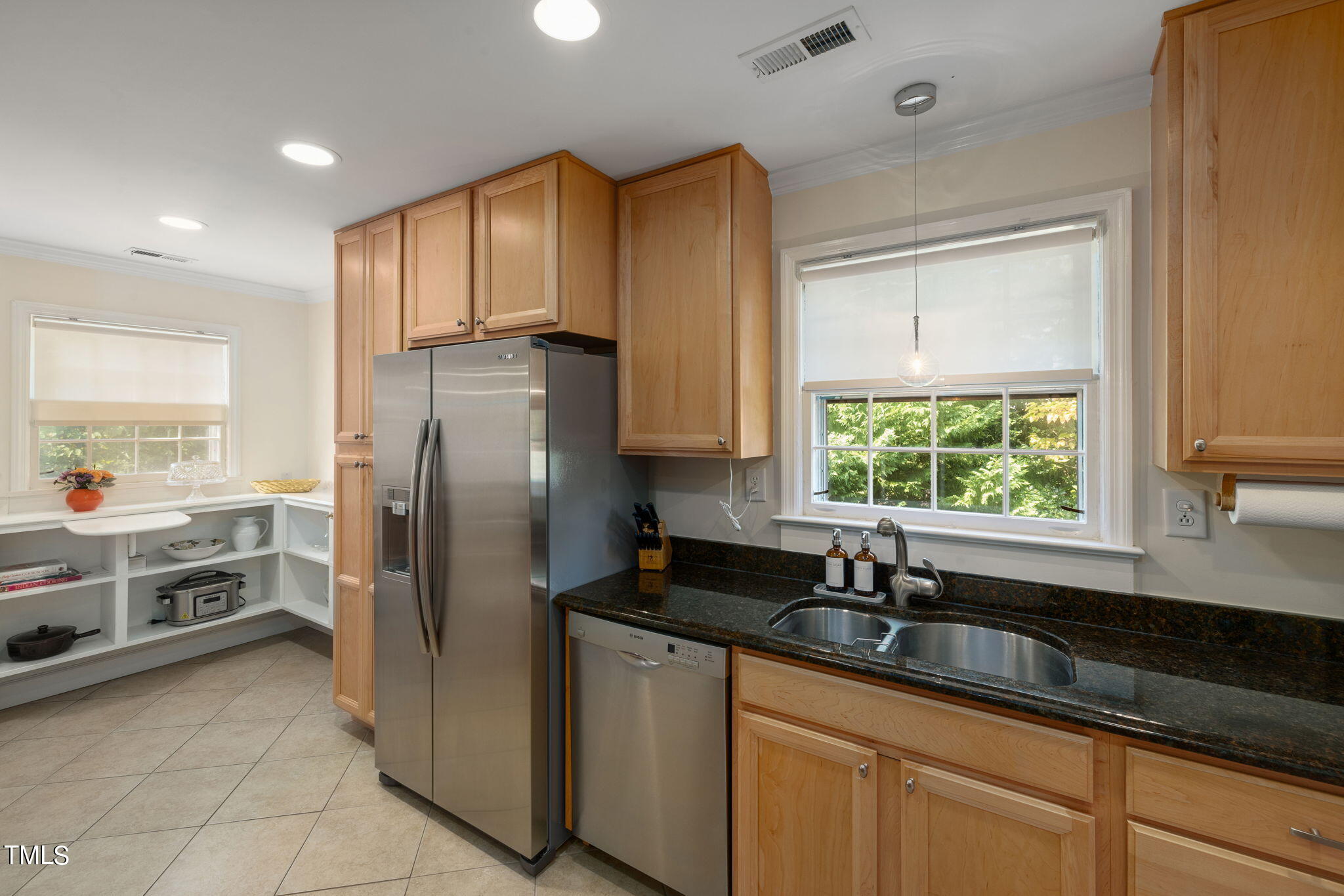 3409 Lewis Farm Road Raleigh, NC 27607 - Photo 9 of 31 a kitchen with kitchen island granite countertop a sink stainless steel appliances and cabinets