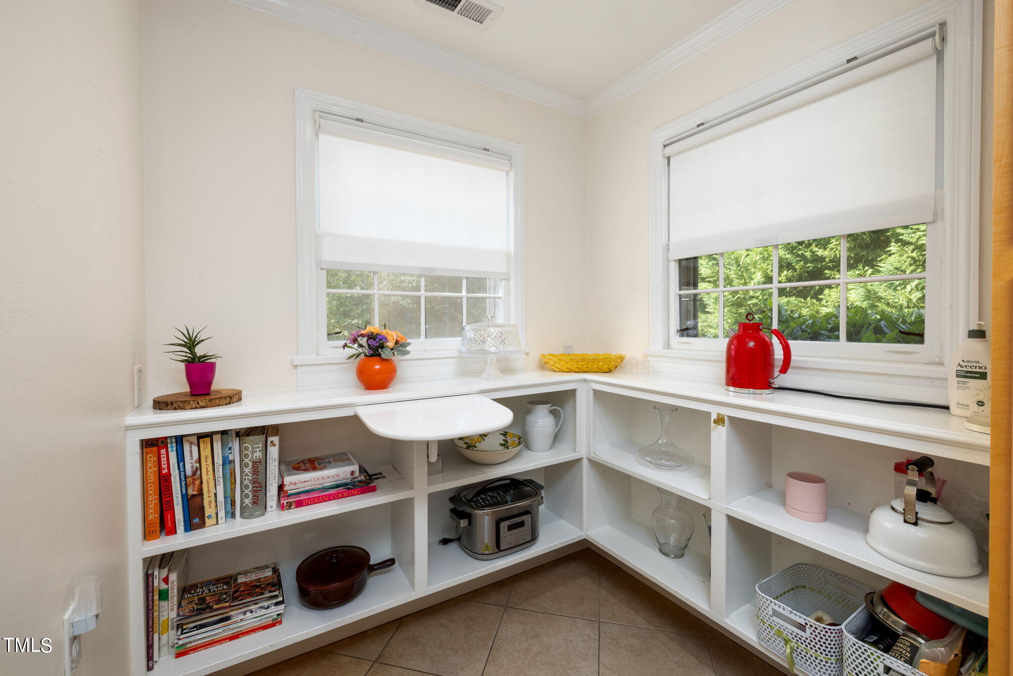 3409 Lewis Farm Road Raleigh, NC 27607 - Photo 10 of 31 a utility room with cabinets and book shelf