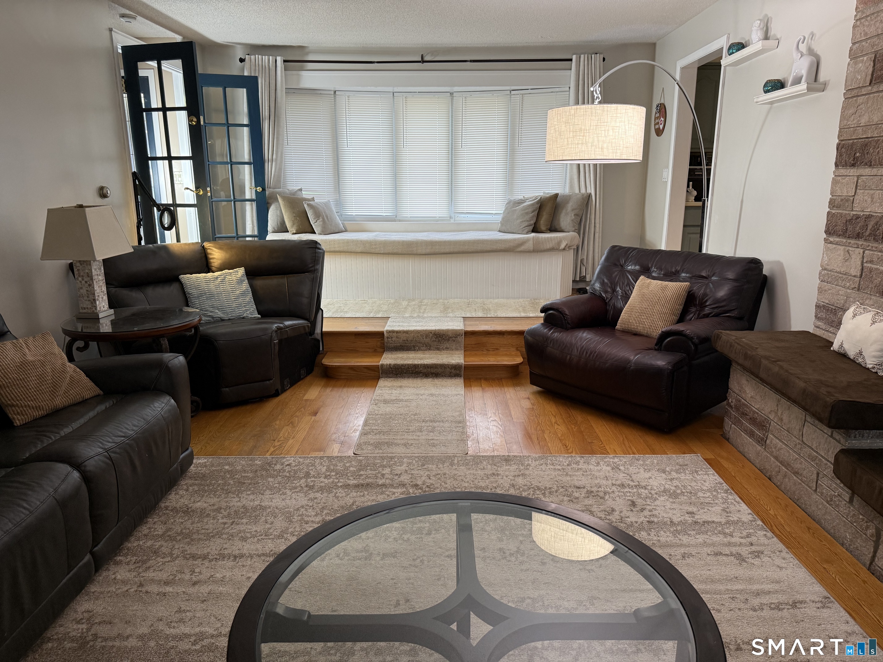 7 Riverview Street Enfield, CT 06082 - Photo 4 of 29 a living room with furniture and a lamp