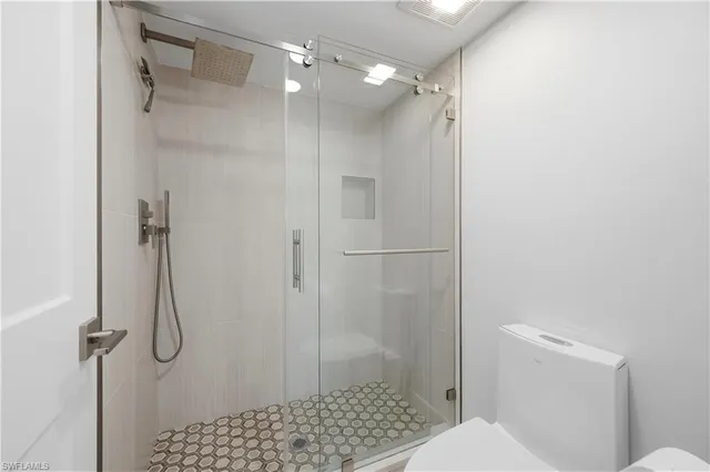 a bathroom with a shower and a toilet