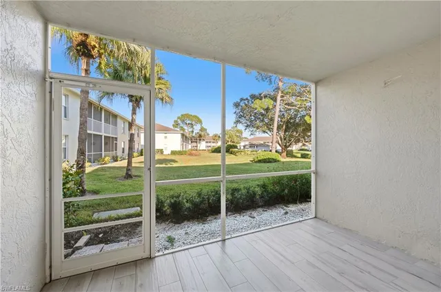 a view of a house with a big yard and large trees