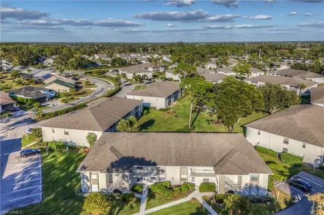 an aerial view of residential houses with outdoor space