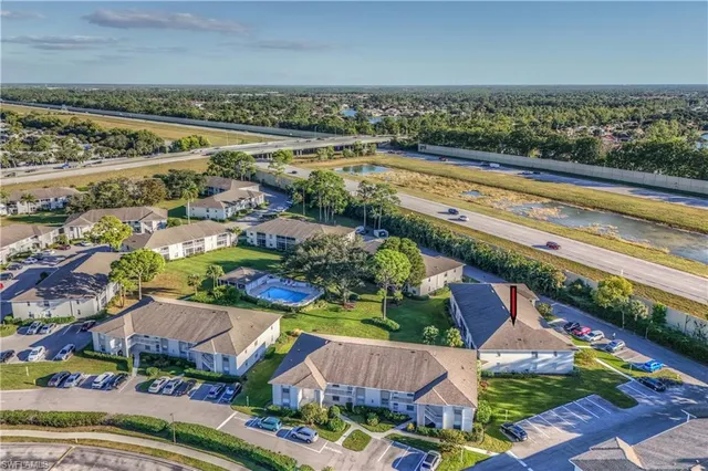 an aerial view of residential building and lake