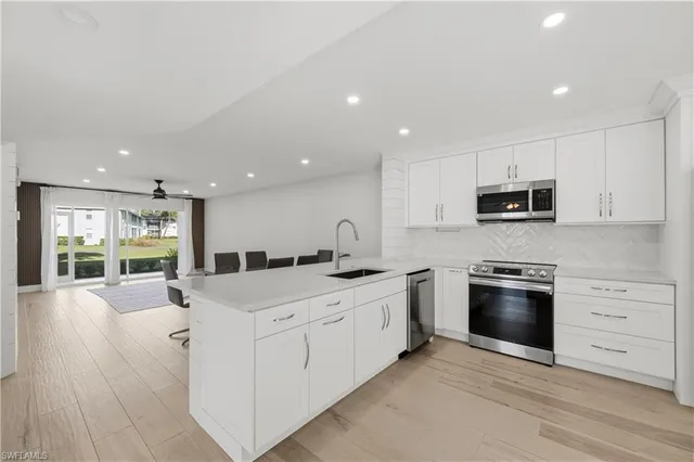a kitchen with stainless steel appliances granite countertop a stove and a sink