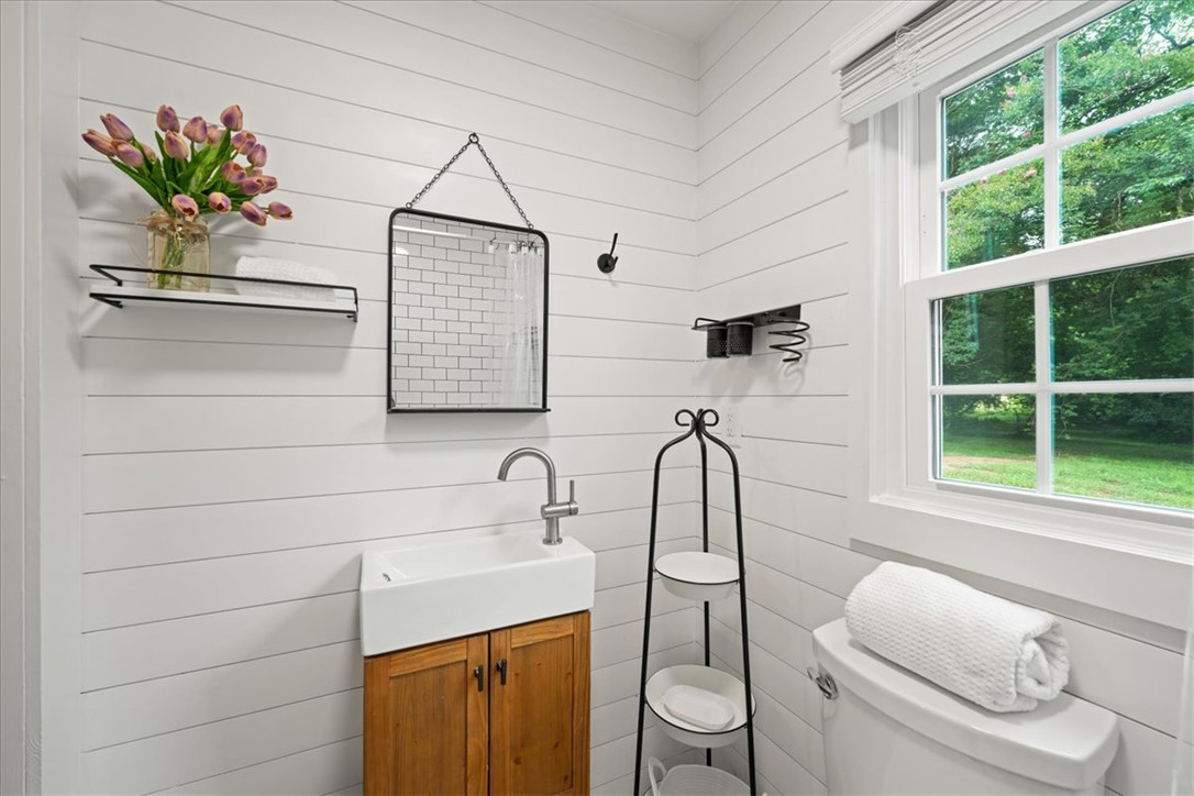 174 Holliday Road Six Mile, SC 29682 - Photo 33 of 49 A well-lit bathroom offers charming shiplap walls and a view of outside