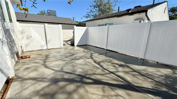 a view of a backyard with a tree