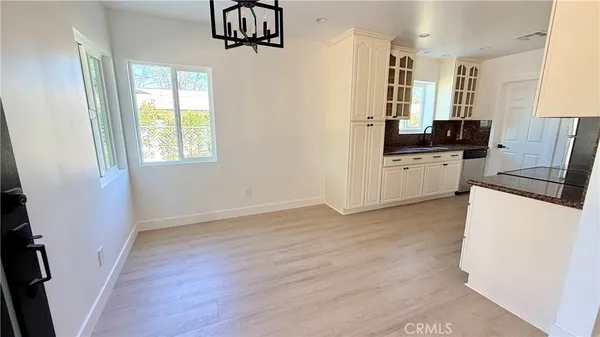 a kitchen with a refrigerator a stove top oven a sink and a window