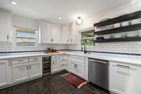 a kitchen with stainless steel appliances granite countertop a stove sink and microwave