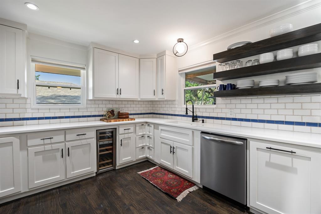 11718 Rogue Way Dallas, TX 75218 - Photo 10 of 35 a kitchen with a sink stove and cabinets