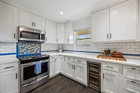 a kitchen with a sink stove and cabinets