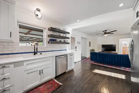 a kitchen with cabinets stainless steel appliances a sink and a stove
