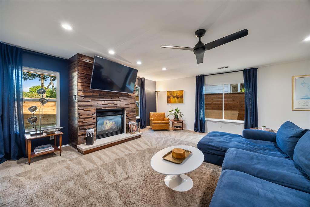 11718 Rogue Way Dallas, TX 75218 - Photo 14 of 35 a living room with furniture a fireplace and a flat screen tv