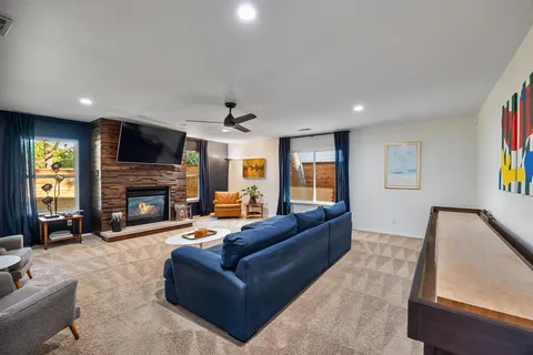 a living room with furniture a fireplace and a flat screen tv
