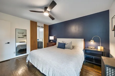 a bedroom with a bed and wooden floor