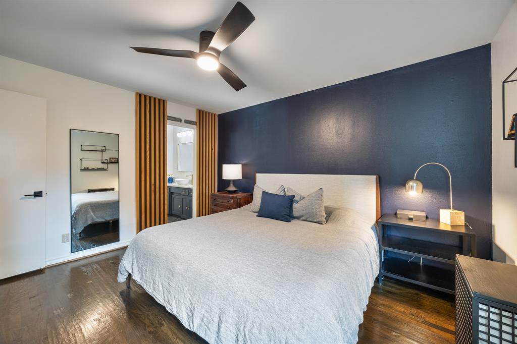 11718 Rogue Way Dallas, TX 75218 - Photo 19 of 35 a bedroom with bed and wooden floor