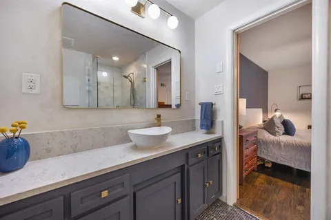 a bedroom with bed and wooden floor