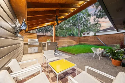 a view of a house with a yard porch and sitting area