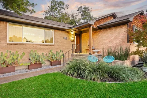 a view of a backyard with plants and a patio