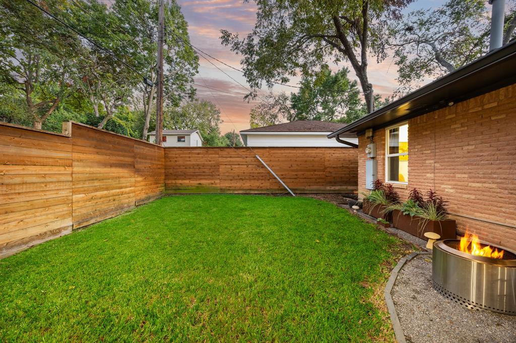 11718 Rogue Way Dallas, TX 75218 - Photo 33 of 35 a view of a backyard with barn plants and large tree