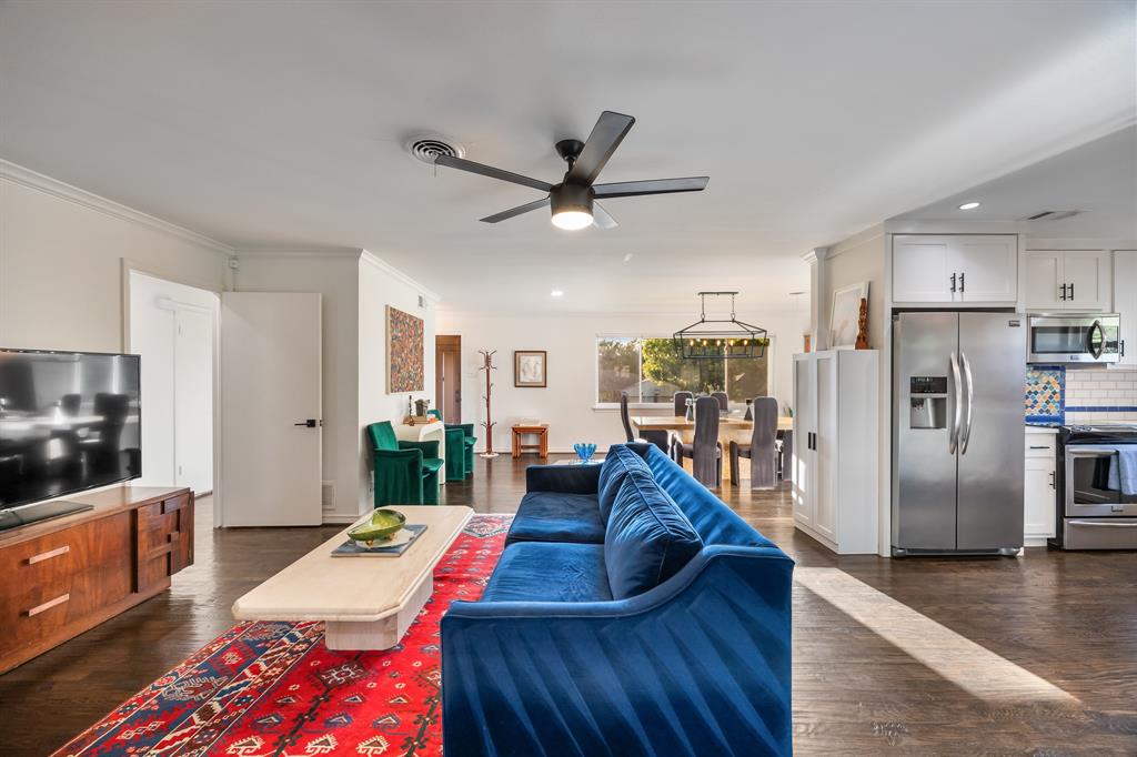 11718 Rogue Way Dallas, TX 75218 - Photo 35 of 35 a large kitchen with stainless steel appliances granite countertop a refrigerator a oven a dining table and chairs with wooden floor