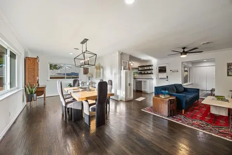 a view of a dining room with furniture window and wooden floor