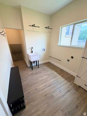 450 13800 South, Unit 2 Draper, UT 84020 - Photo 19 of 21 Spacious utility room featuring wood-finish flooring, a utility sink with a matte black faucet, and a large window providing natural light
