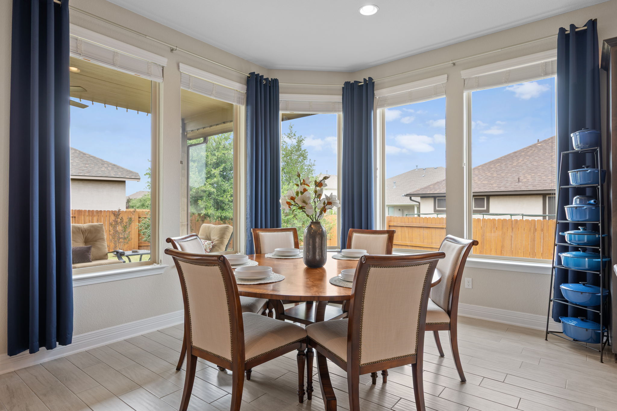 408 Bell Boot Pass Georgetown, TX 78626 - Photo 13 of 40 Inviting dining area featuring light-colored flooring, a rounded wooden table, and large bay windows offering views of the outdoors