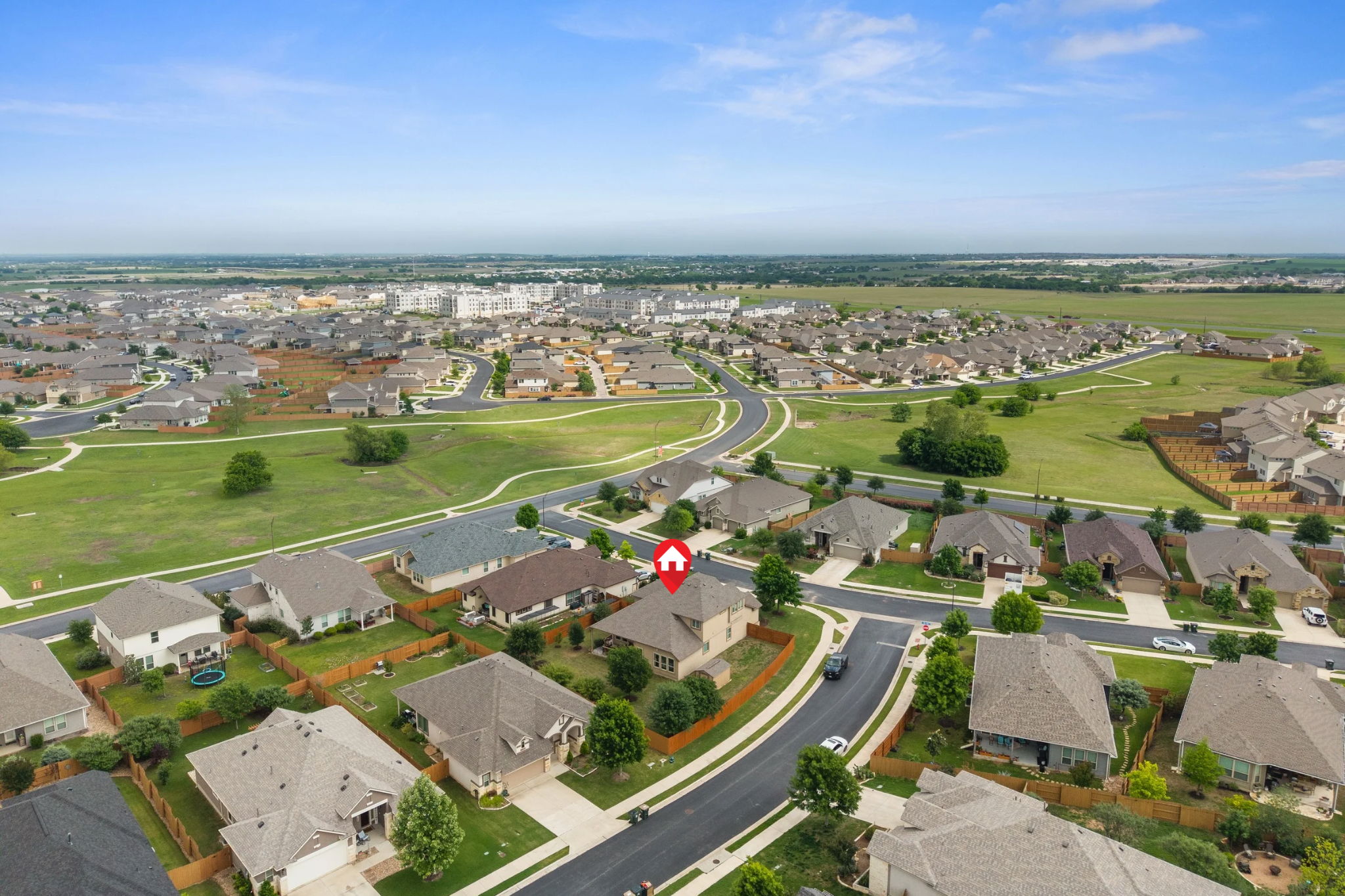 408 Bell Boot Pass Georgetown, TX 78626 - Photo 36 of 40 Aerial view of the property and its surrounding neighborhood, featuring residential streets, green spaces, and a clear sky