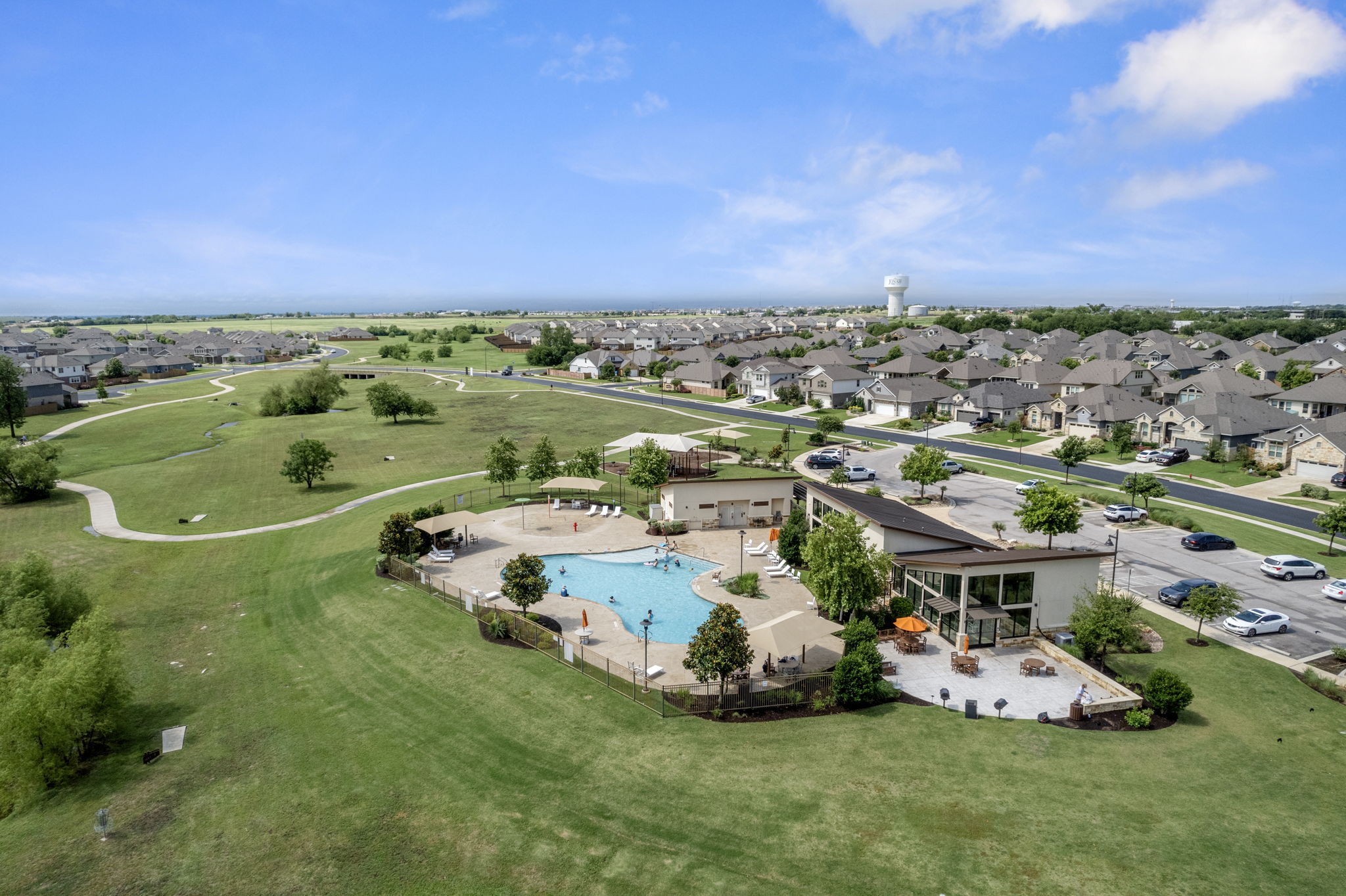 408 Bell Boot Pass Georgetown, TX 78626 - Photo 38 of 40 Aerial view showcasing the community pool, a surrounding green space, and nearby residential properties