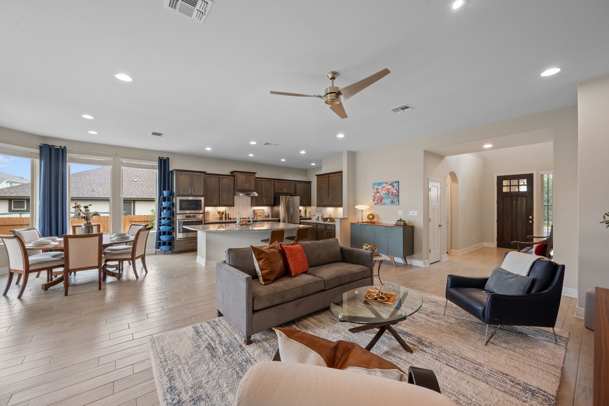 408 Bell Boot Pass Georgetown, TX 78626 - Photo 6 of 40 The property features an open concept living area with light-colored flooring, recessed lighting, and a ceiling fan