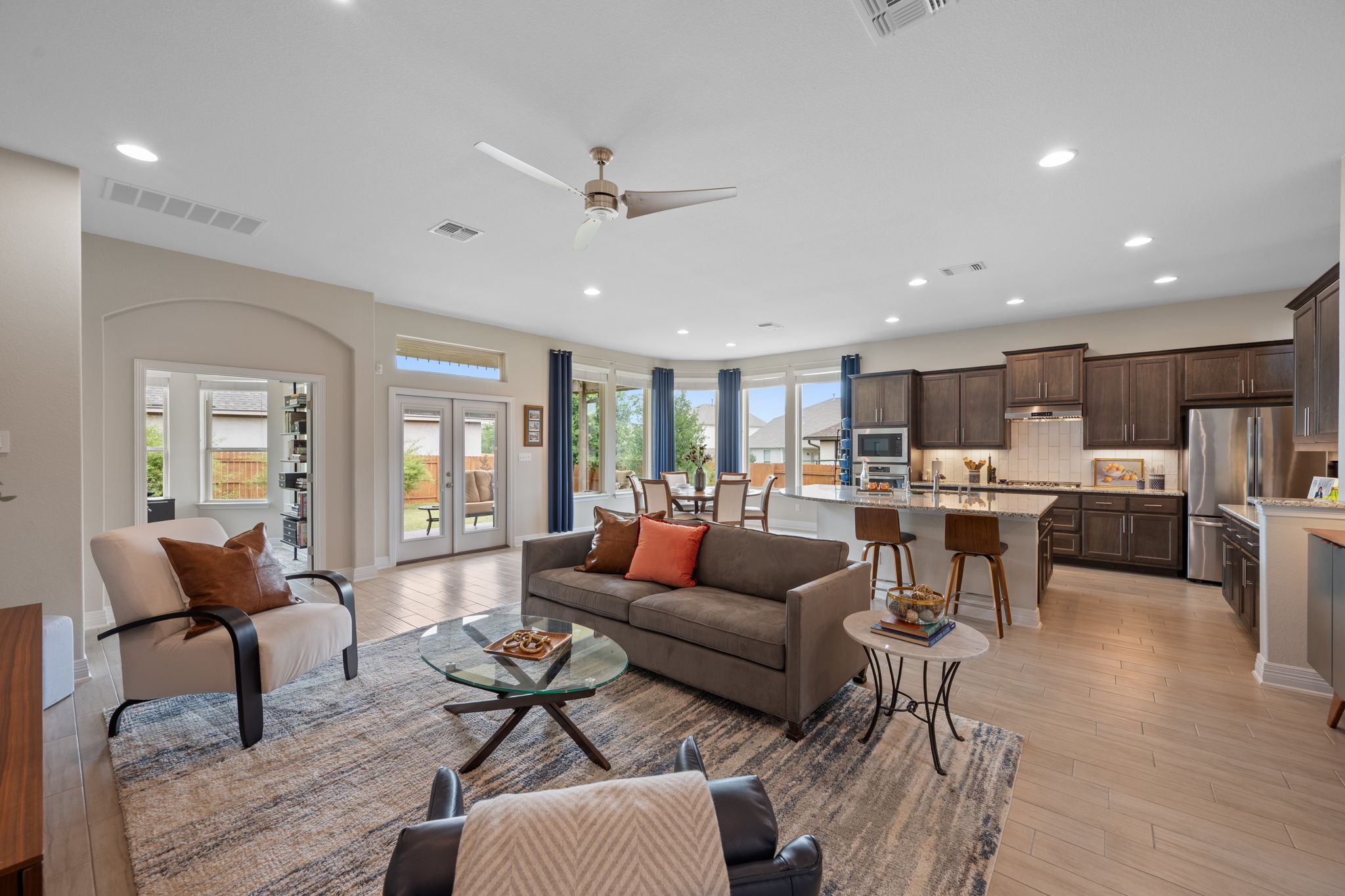 408 Bell Boot Pass Georgetown, TX 78626 - Photo 8 of 40 Open concept living area featuring light-colored flooring, recessed lighting, and a ceiling fan