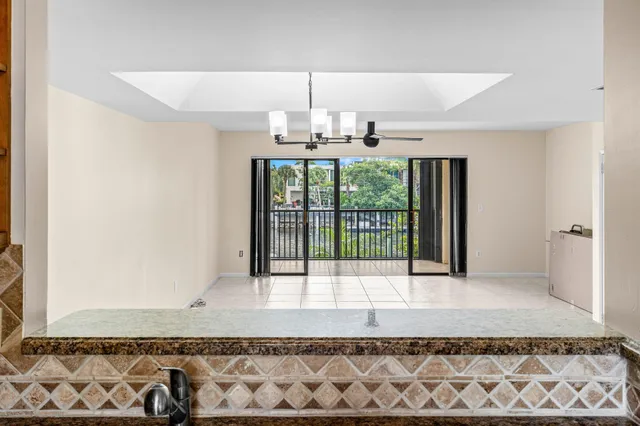 a view of a livingroom with wooden floor and chandelier